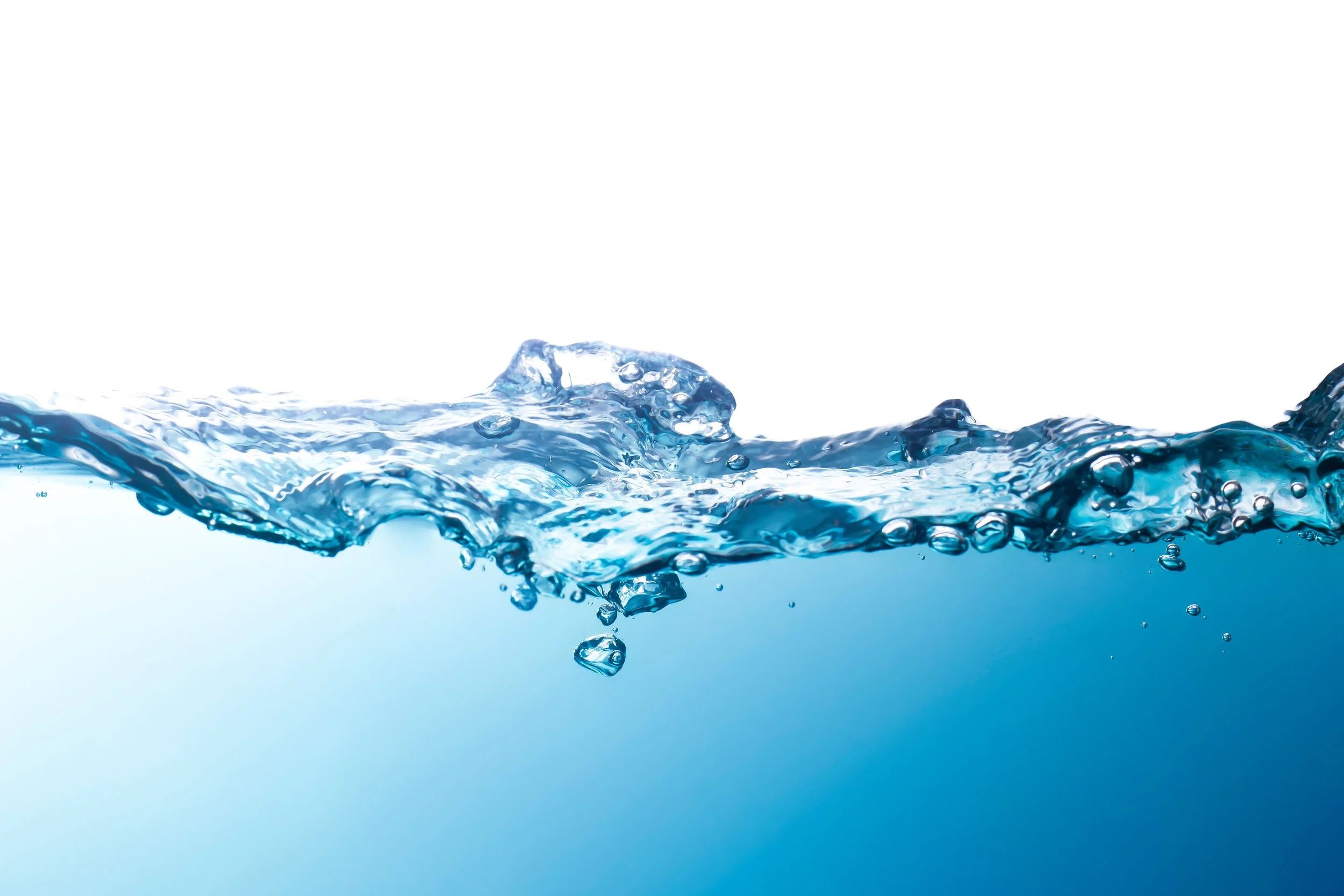 Close-up of clear blue water splashing with bubbles and ripples.