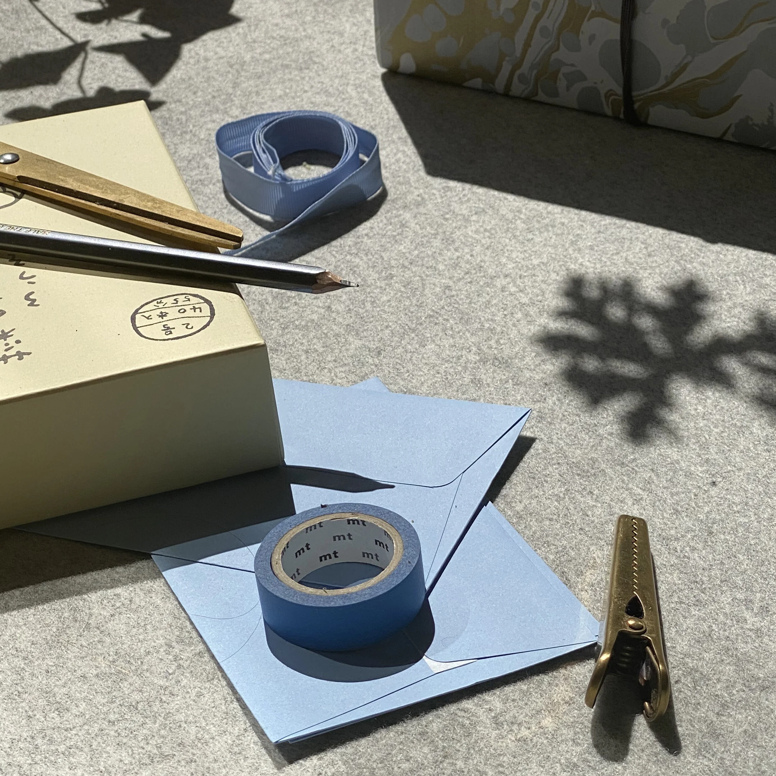 Scissors, ribbon and tape alongside a special birthday gift, which we sourced from Japan.