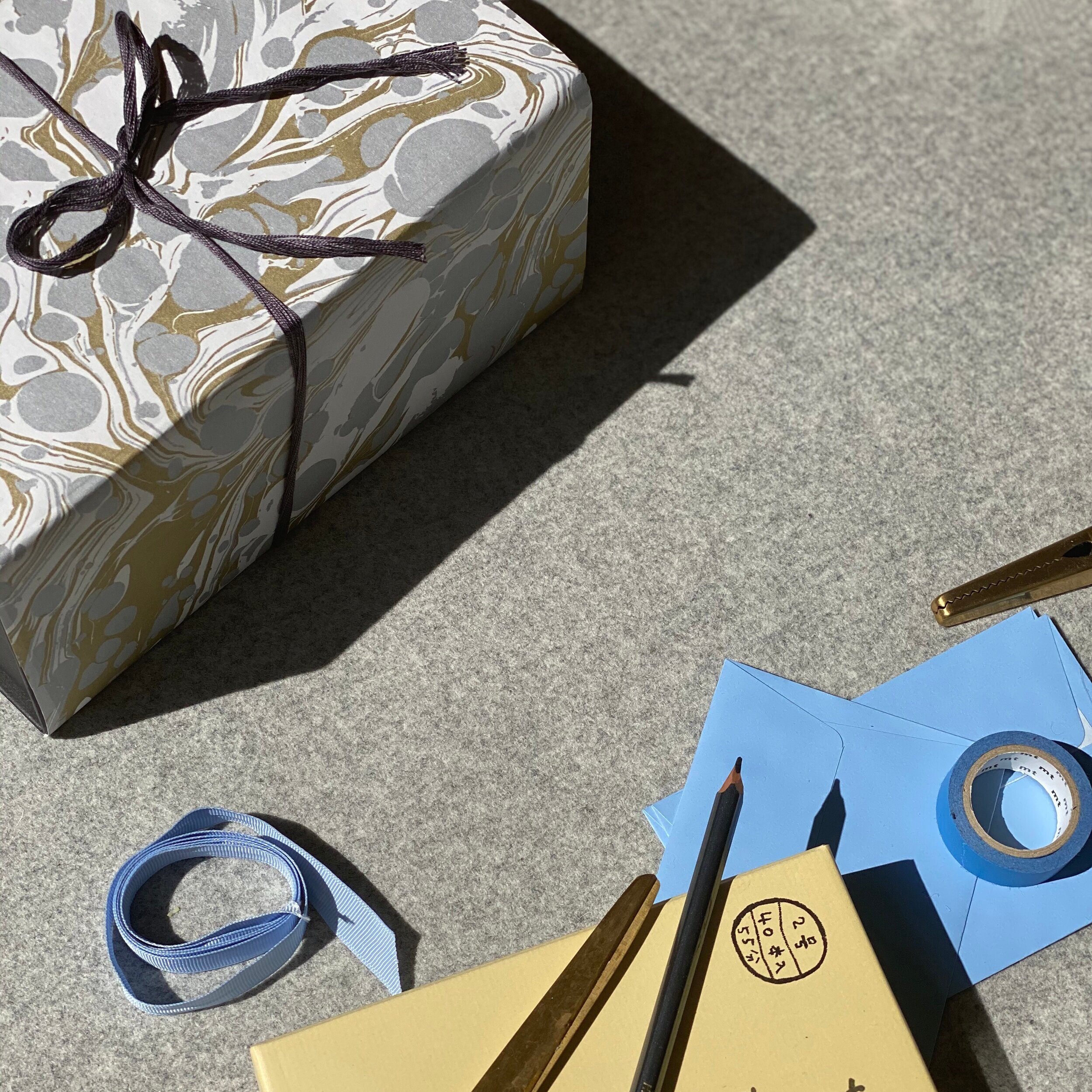 Gift wrapped in gold and silver paper with ribbon.
