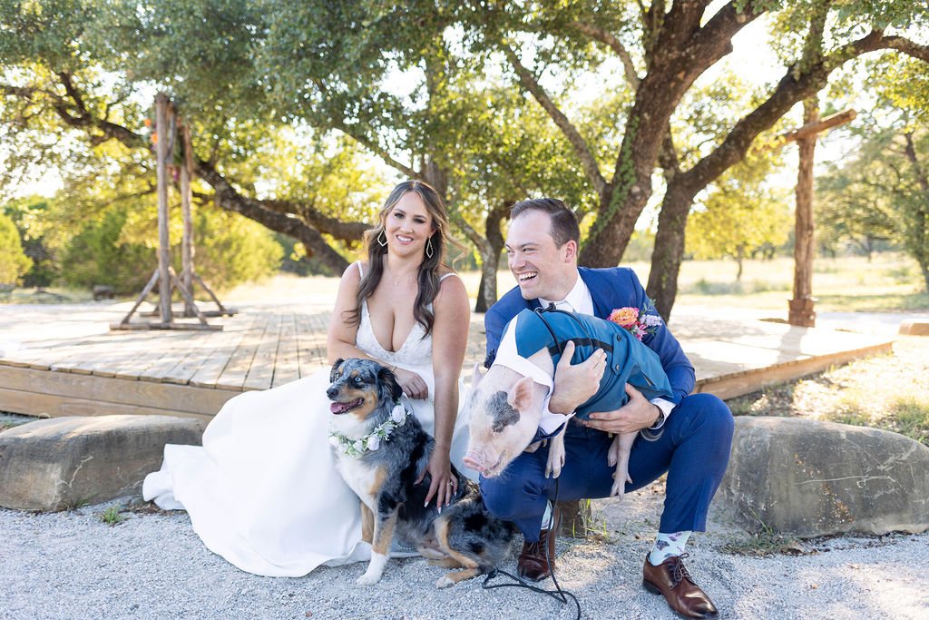 Couples portrait after the wedding with their pet dog and pig for a full ranch wedding!