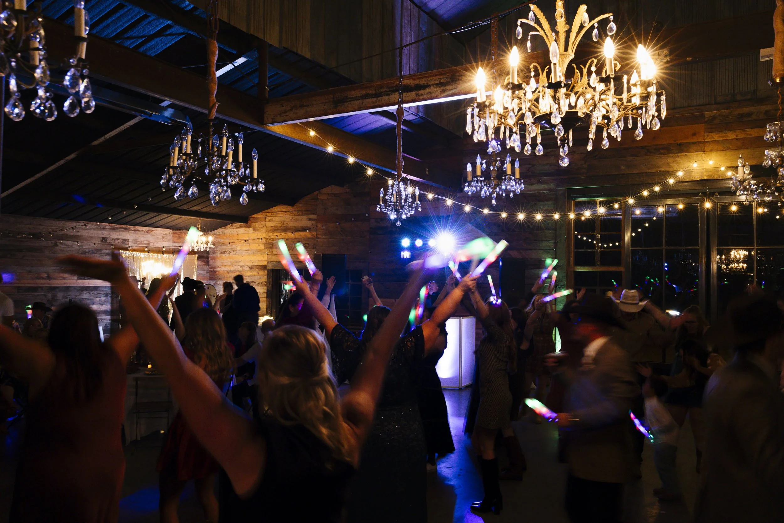 Photo of couple dancing with their guests on the epic dance floor at sparrow creek ranch.