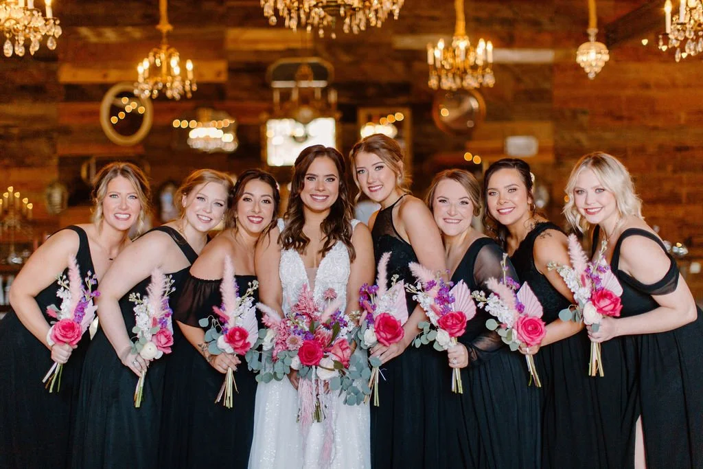 bride and bridesmaids smiling holding hot pink flowers in north texas wedding