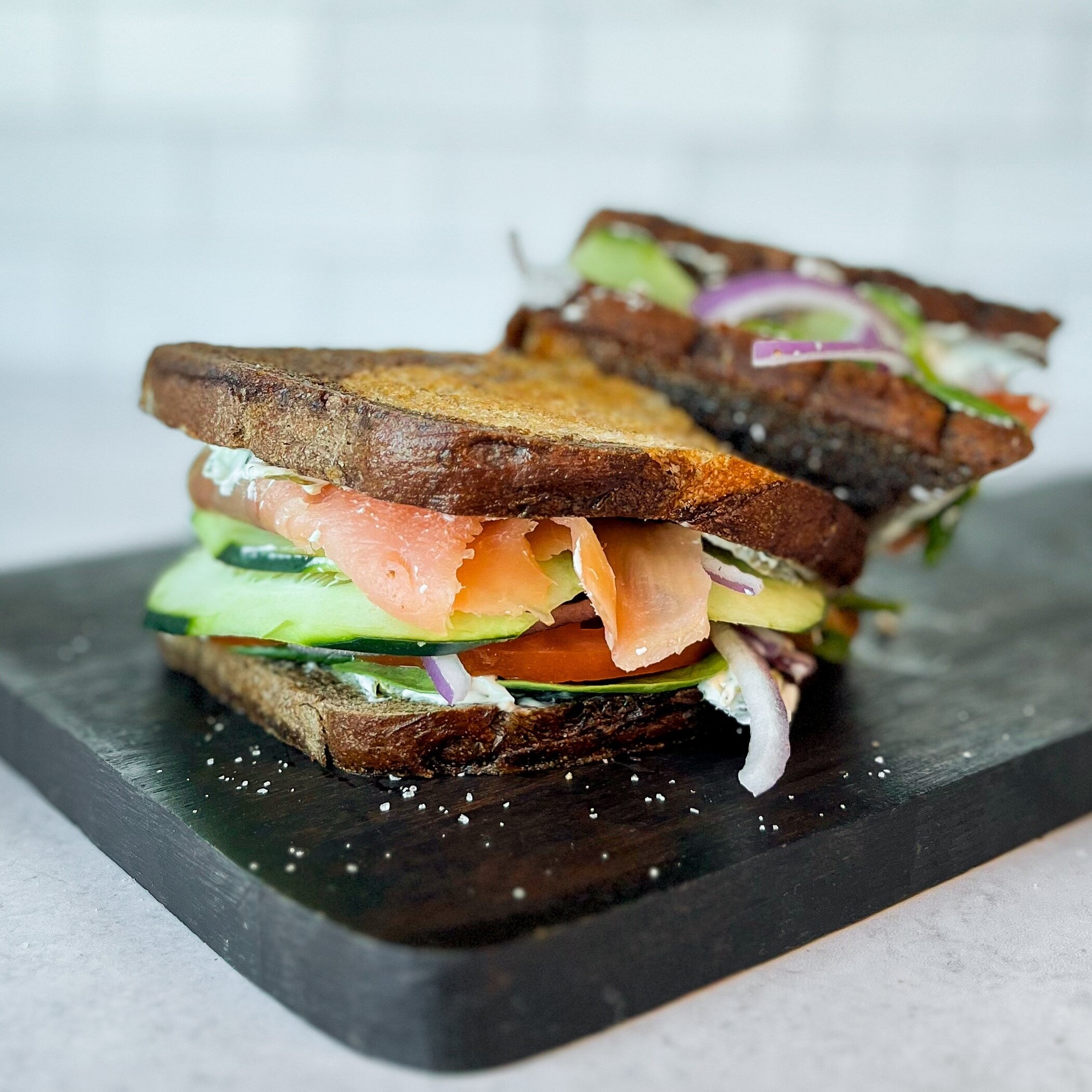 This smoked salmon on rye at the Wedge Parkway location is as fresh and delicious as it looks!! 🥒🍅
Cold smoked lox with shaved red onion, sliced tomato, cucumbers, spinach, and lemon caper dill cream cheese spread served on toasted rye bread! #salm