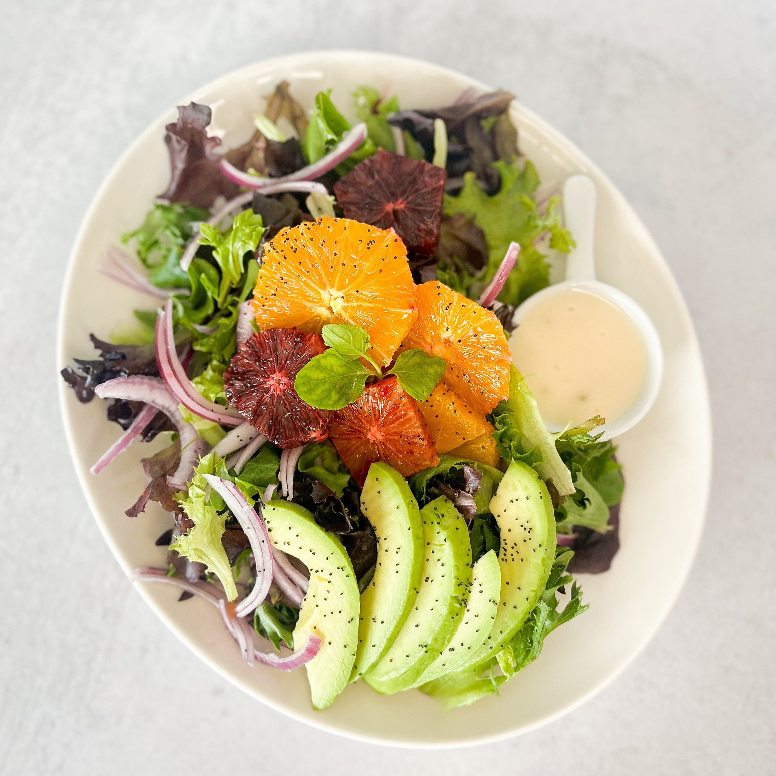 California Avenue location has a beautiful Citrus Avocado Salad this week 🍊🌞🥑 
A bed of baby greens topped with shaved red onion, fresh mint, poppyseeds, &amp; avocado with fresh segments of blood orange and naval oranges served with a citrus mint
