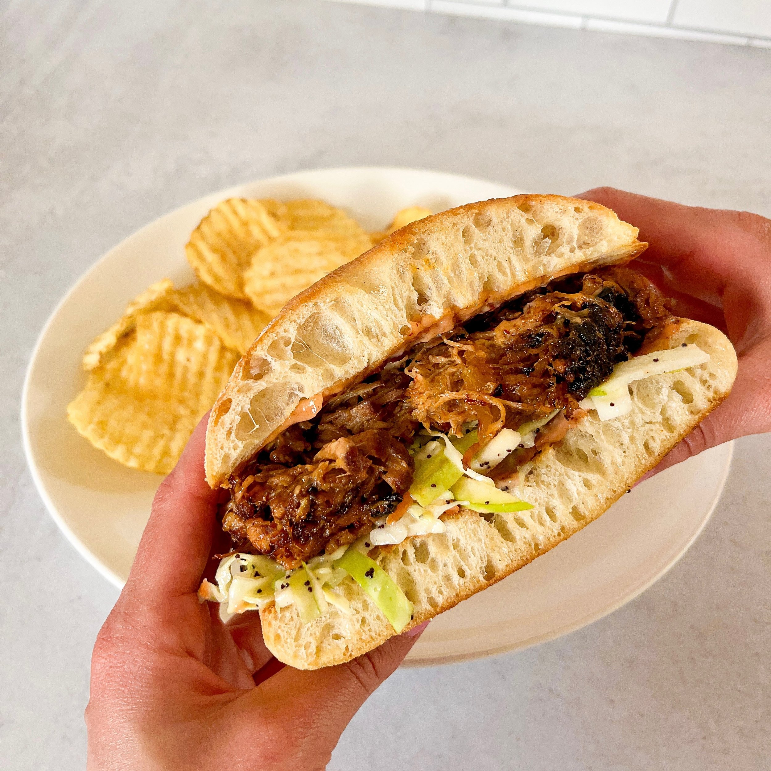 Mouth watering Pulled Pork Sandwich at California Ave location this week!! 🍖 slow roasted tender pork smothered in cranberry honey chipotle bbq sauce and topped with a fresh apple poppyseed slaw served on toasted ciabatta bread. #pulledpork #sandwic