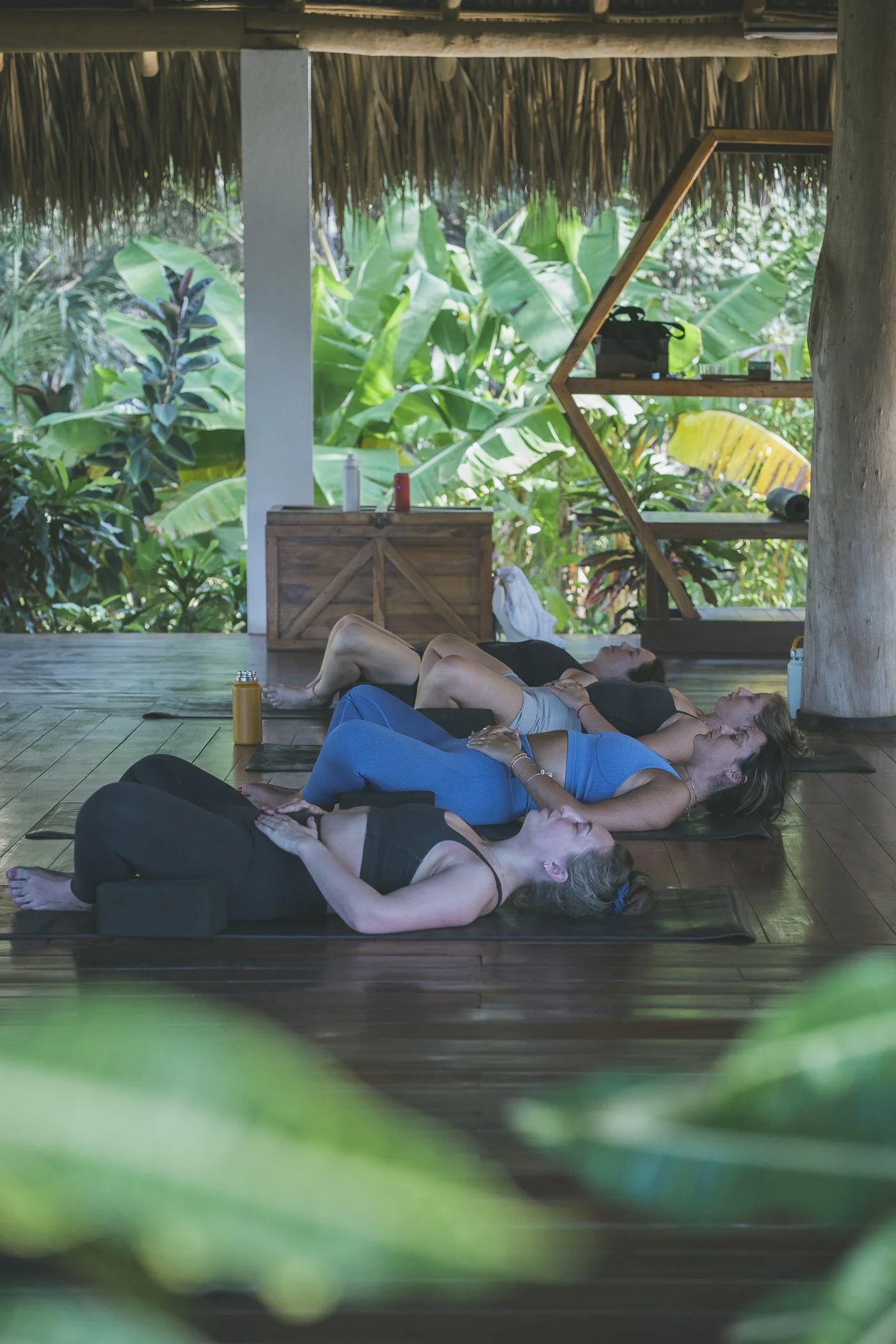 Group in a restorative yoga class in the open-air jungle shala at Still Salty Escape in Nicaragua