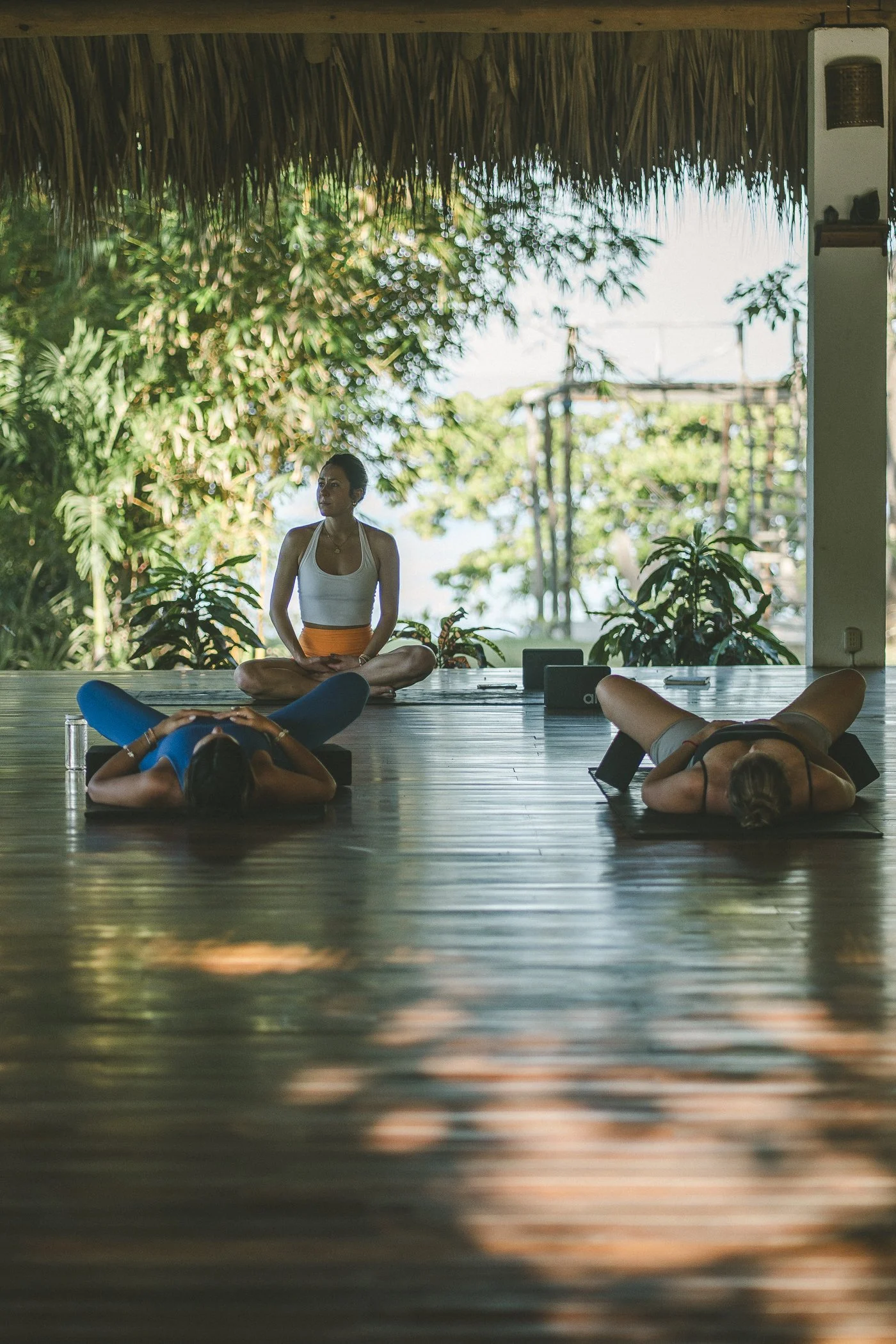 Teacher leading a yoga class in the open-air shala during a retreat at Still Salty Escape in Nicaragua