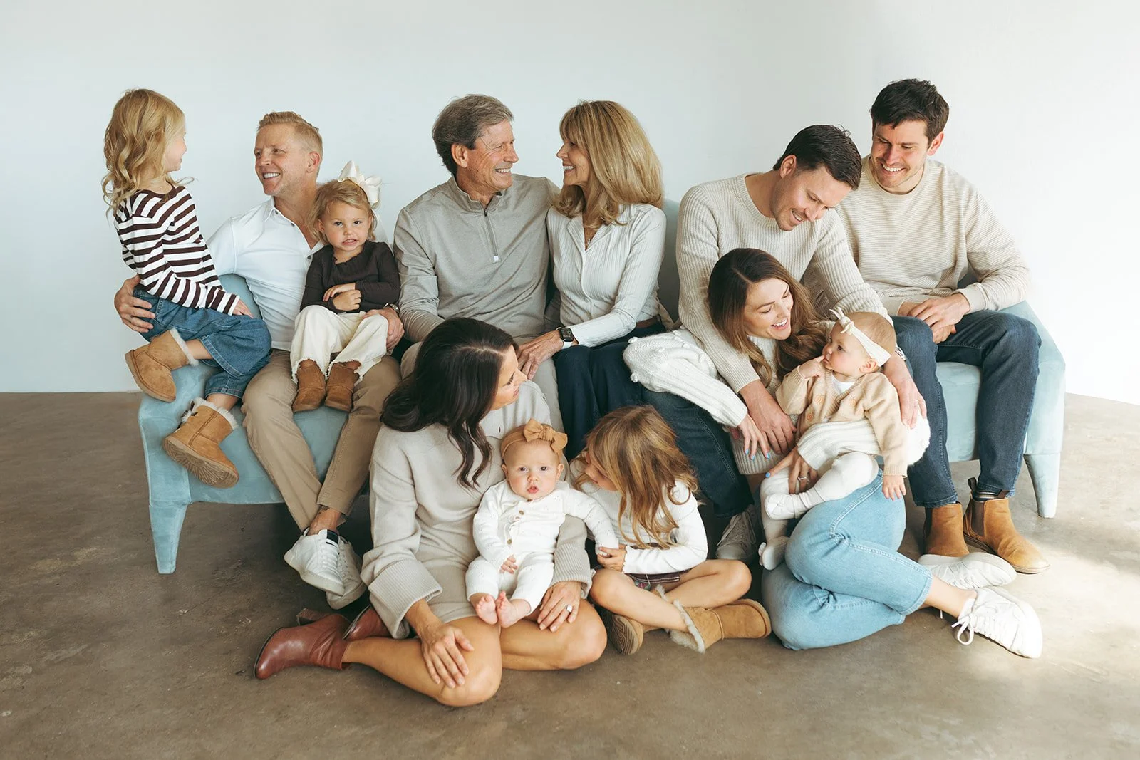 Modern house with wooden façade and large glass window, situated in a mountainous landscape with dry grass in the foreground.