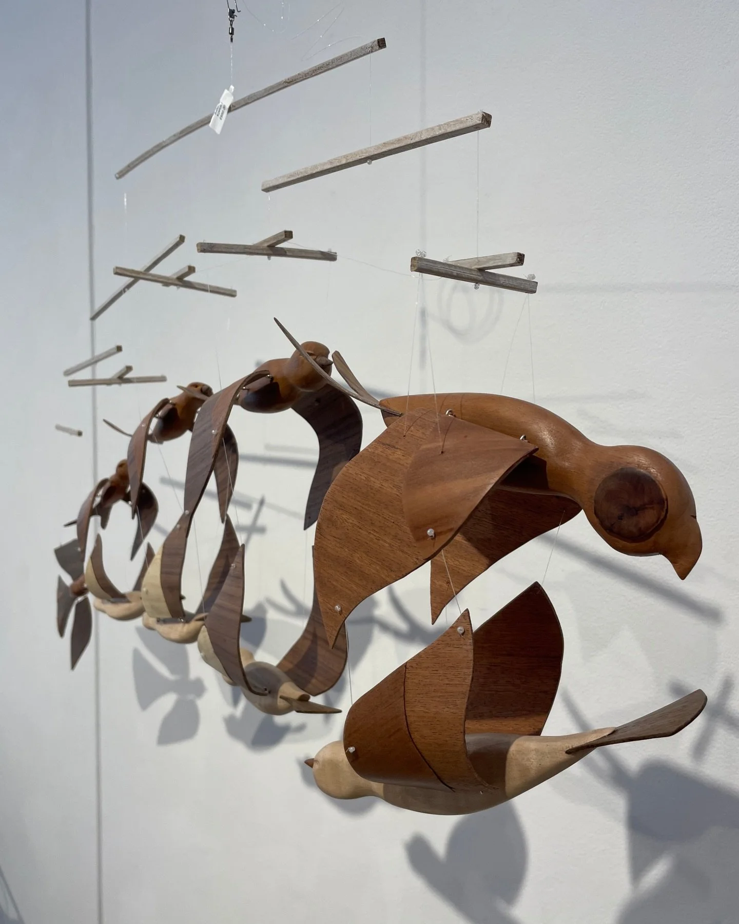 KINETIC exhibitor Jay Rubinstein (@jrubinstein463) makes wooden mobiles, designed to be as light as possible to enable them to move easily in light air currents. Most, though not all, have been in response to an image in a poem or a story.

Jay is in