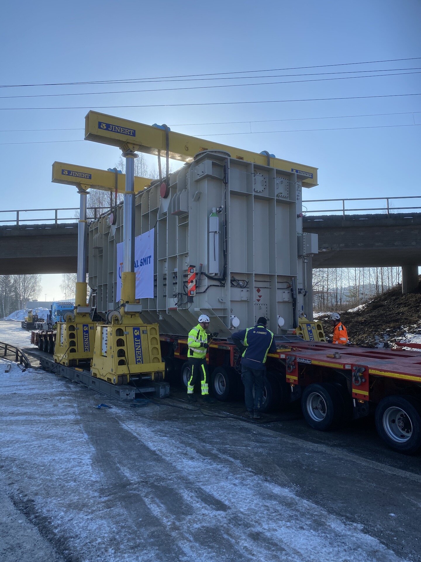 Hydra-Slide low profile system skids transformer under bridge and onto foundation
