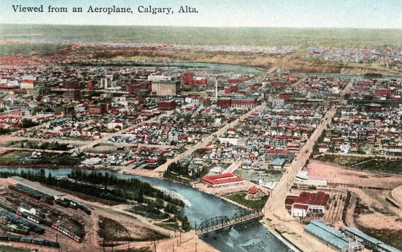  The wide north-south street that begins in the right foreground and continues toward the top right corner of the photograph is 2 Street East, now known asMacleod Trail. The buildings at the north end of the bridge are the streetcar barns. 