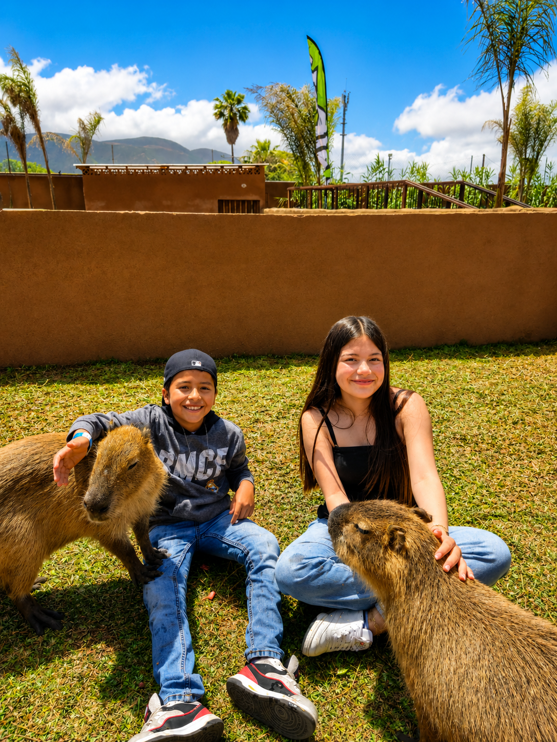 Kids petting capybaras in Pai Pai Animal Center