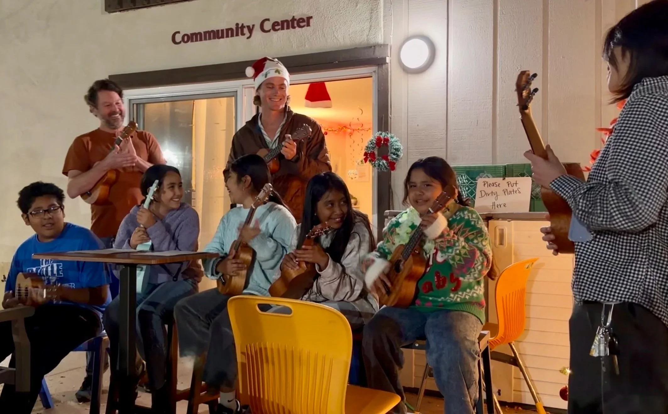 Kids at the Lighthouse playing the ukulele