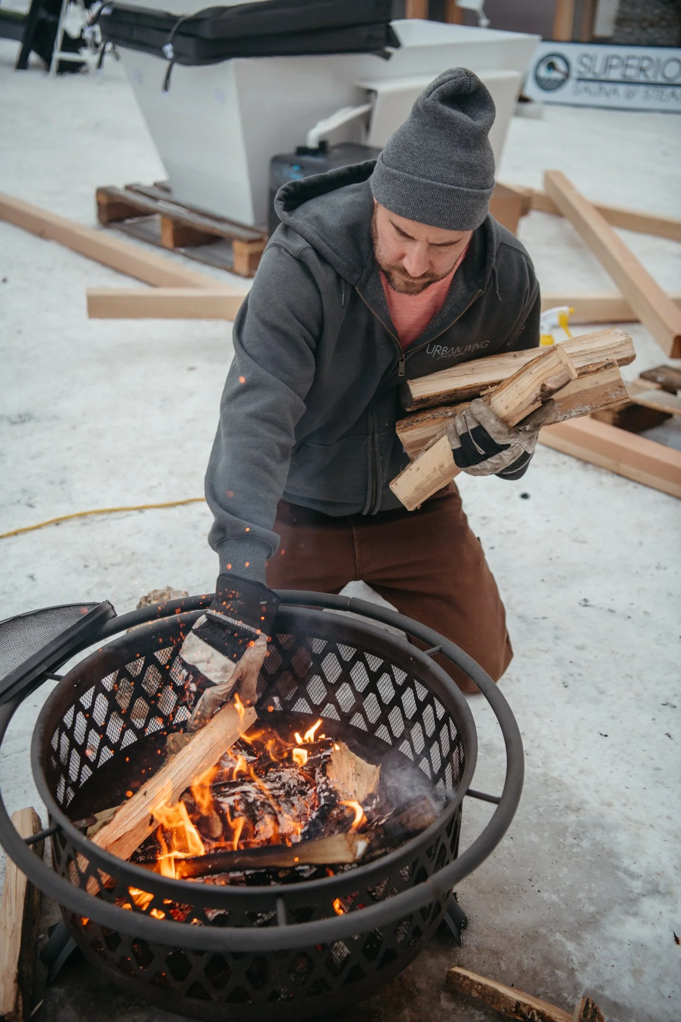 Tending the fire at Sauna Village, The Great Northern Festival 2023.