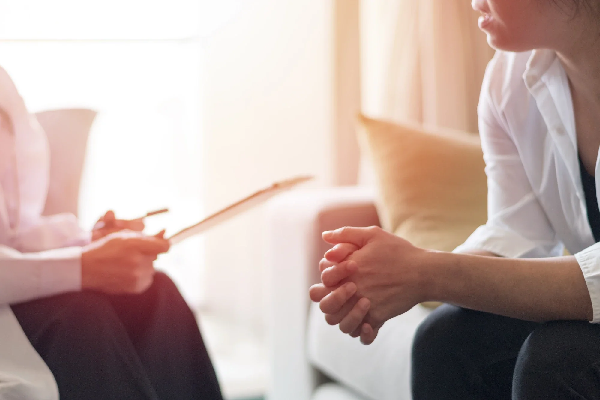 Therapist speaking privately with a client during an individual addiction therapy session.