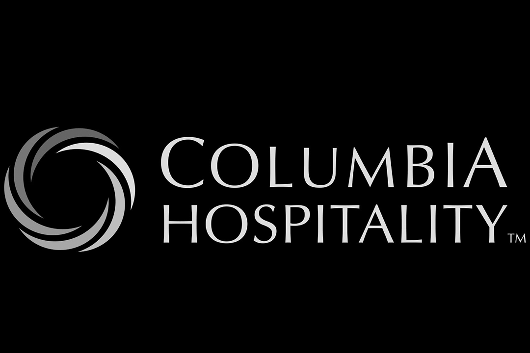 Black background with gray and white logo of Columbia Hospitality, featuring a swirling circle design and the company name in stylized font.