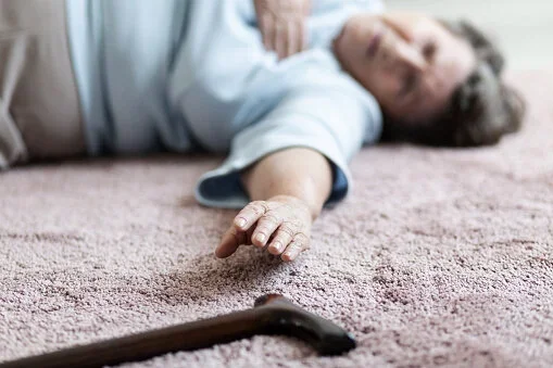 A physiotherapist conducting a home hazard assessment in a Christchurch living room to prevent falls.