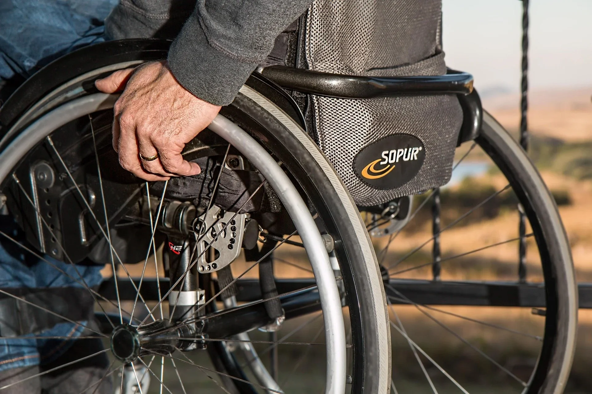 A therapist assessing a patient's wheelchair seating posture to ensure correct ergonomic alignment.