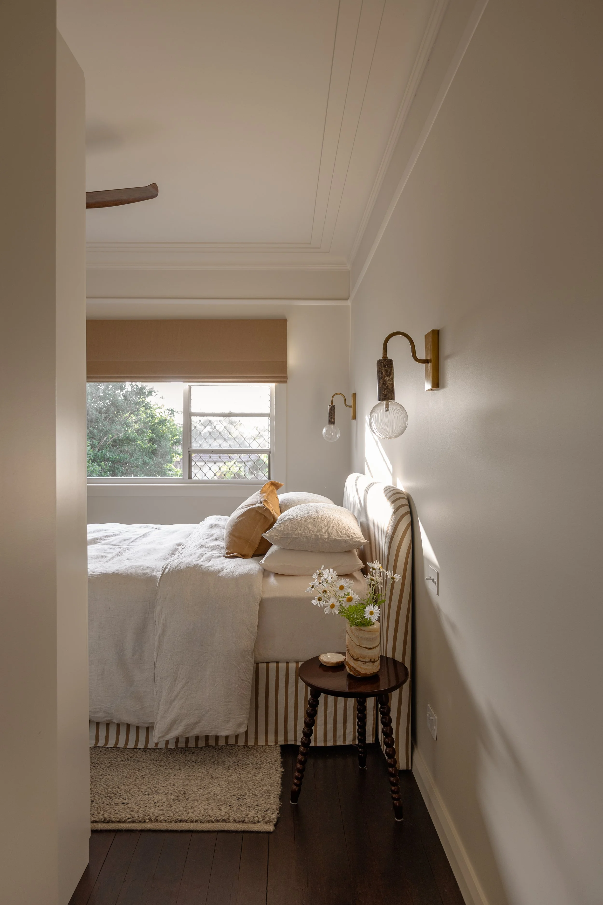Bedroom with wall lights and natural lighting
