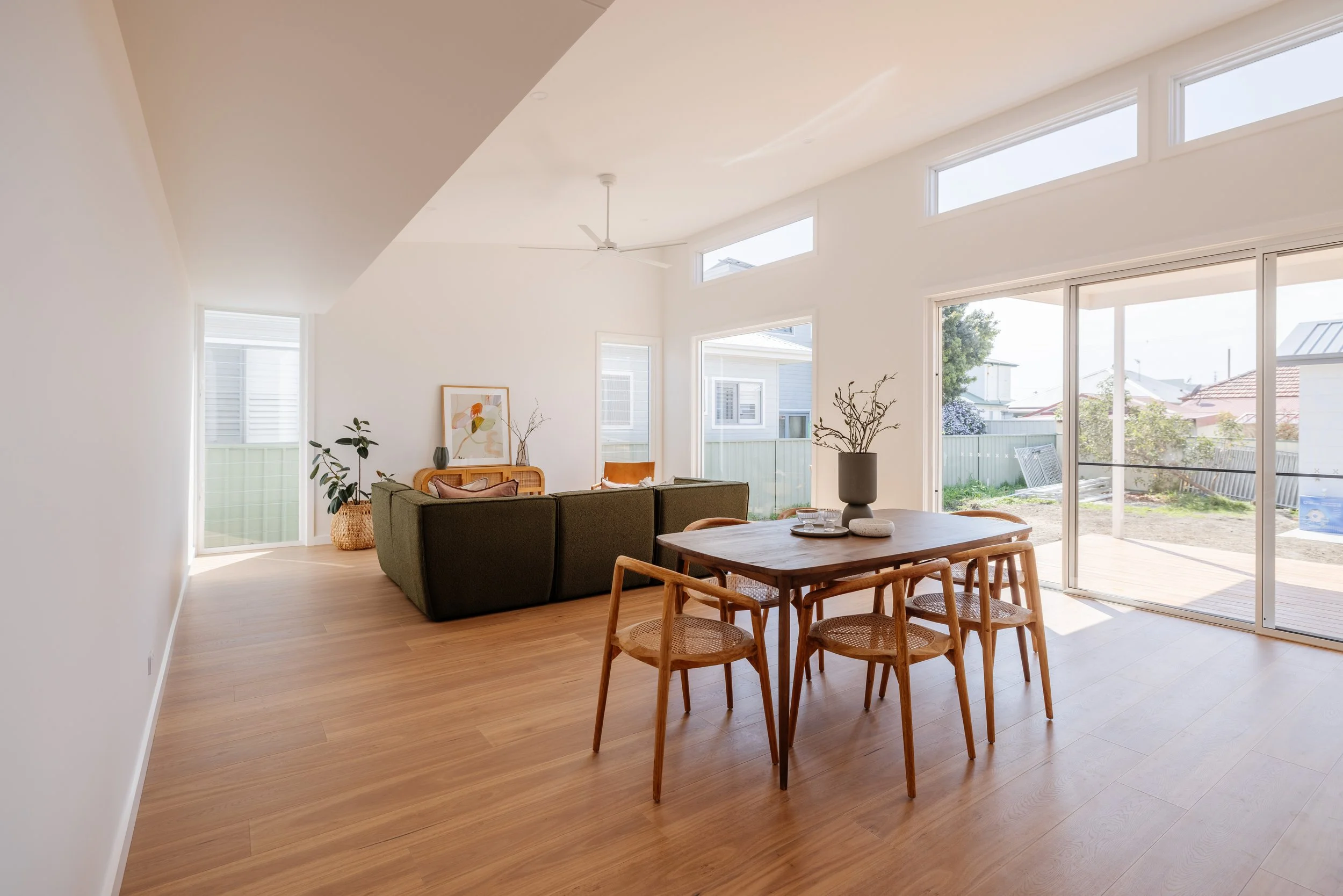 Open plan living area in house with large windows