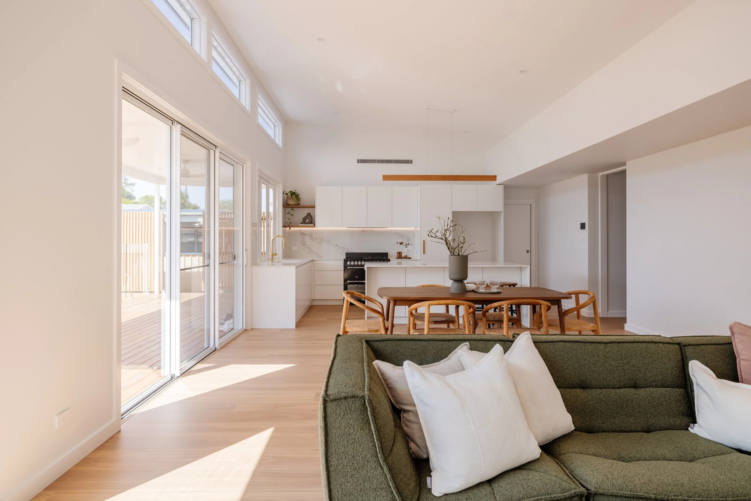 Open plan living and kitchen area in house with large window