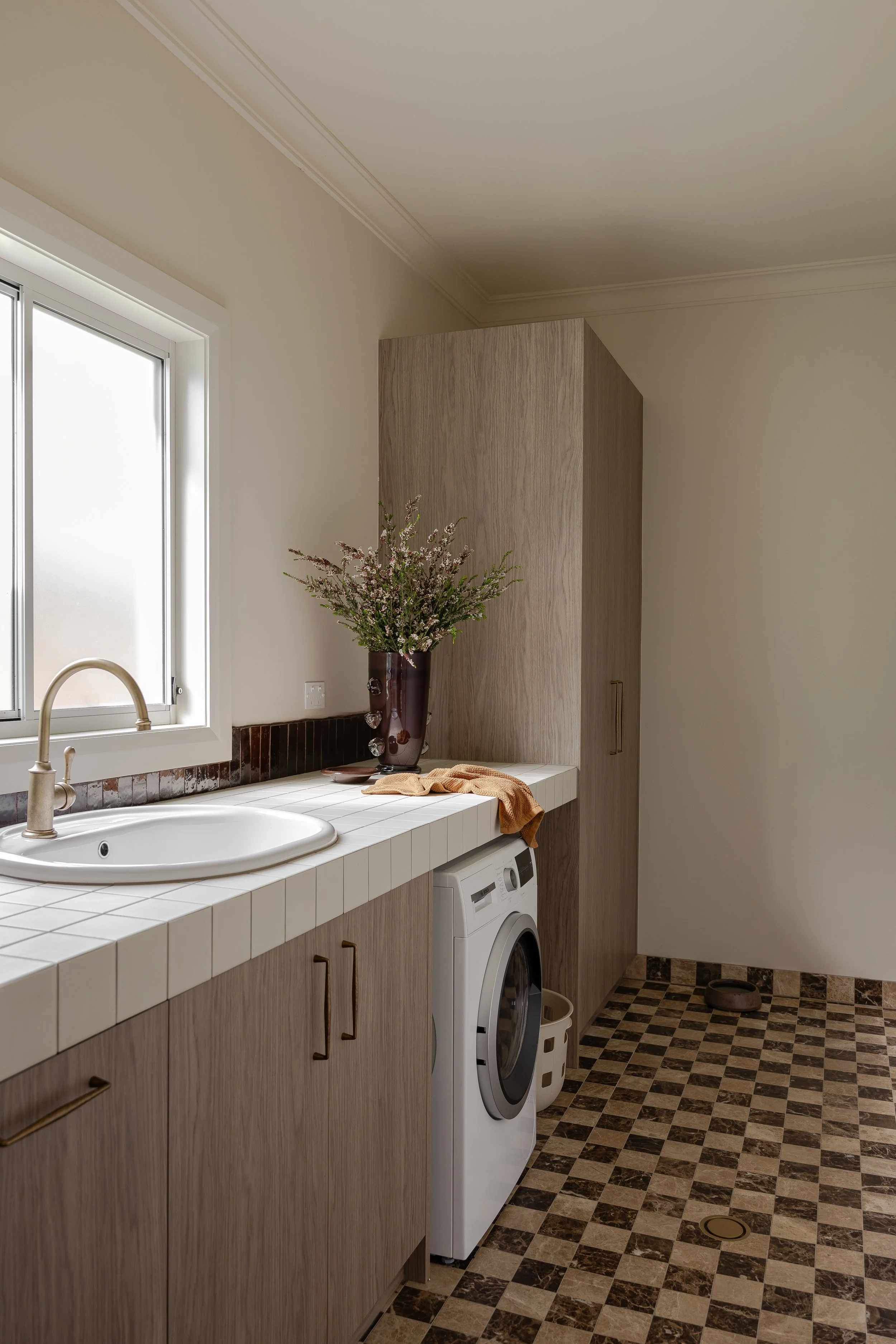 Laundry with tile bench tops and backsplash