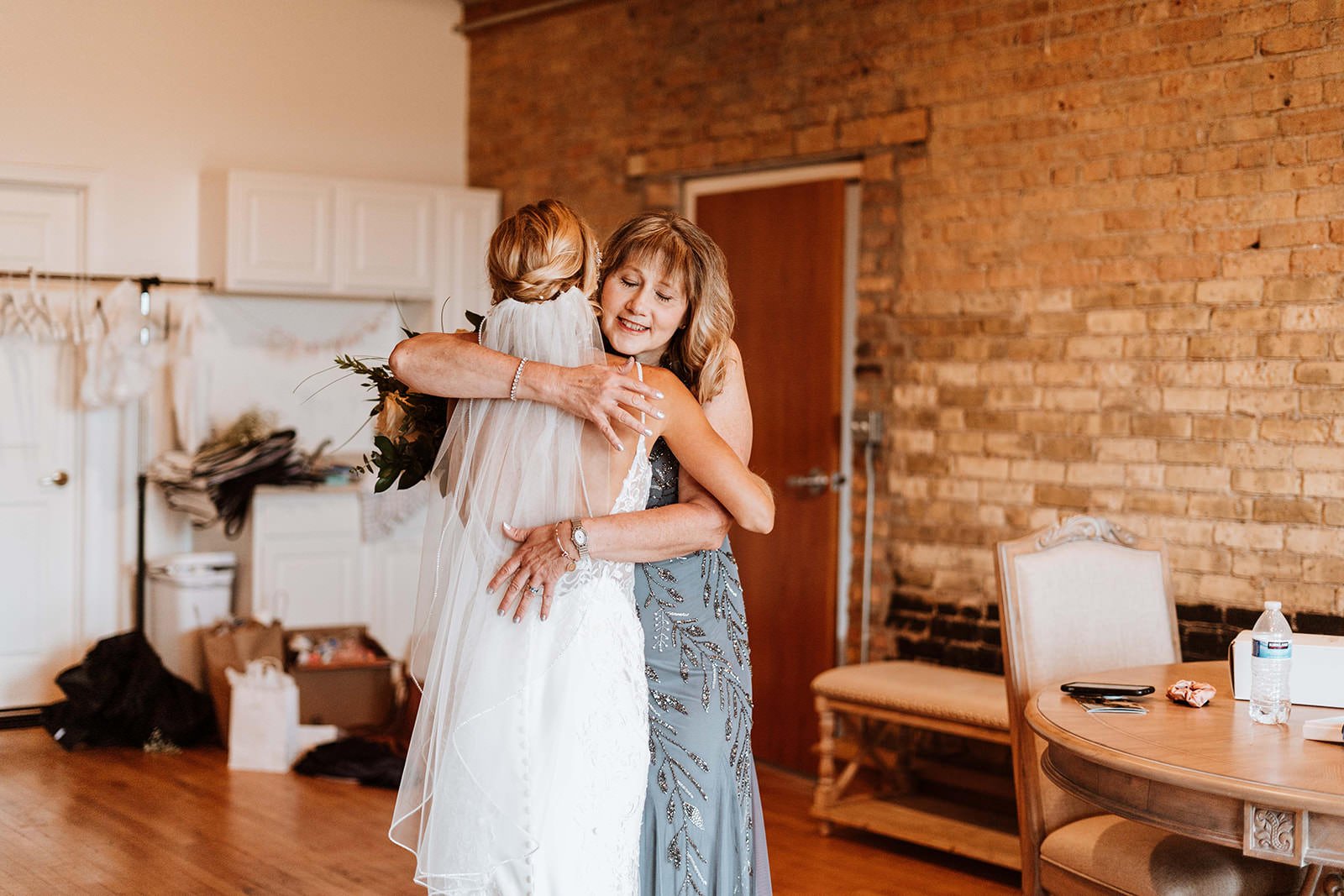 Bride hugs her mom after seeing her for the first time before her ceremony