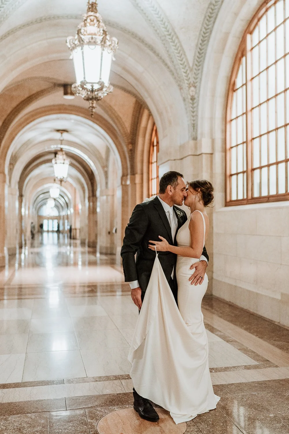 newlywed man and woman kissing inside the Chicago City Hall