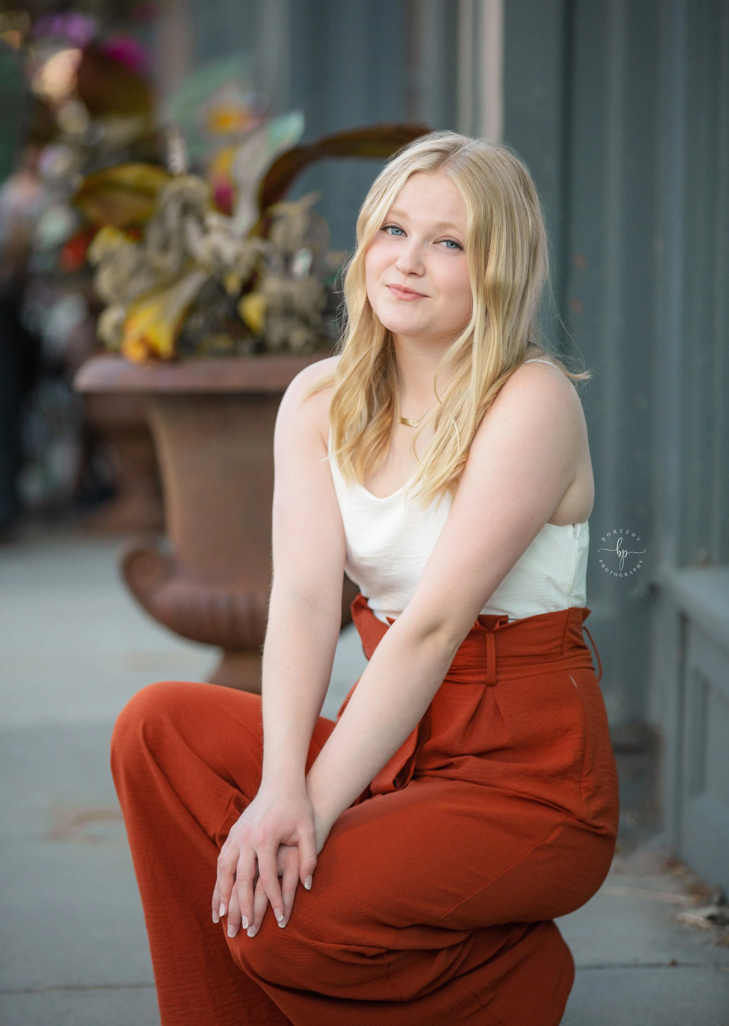 maple grove senior photographer downtown excelsior girl sitting pose