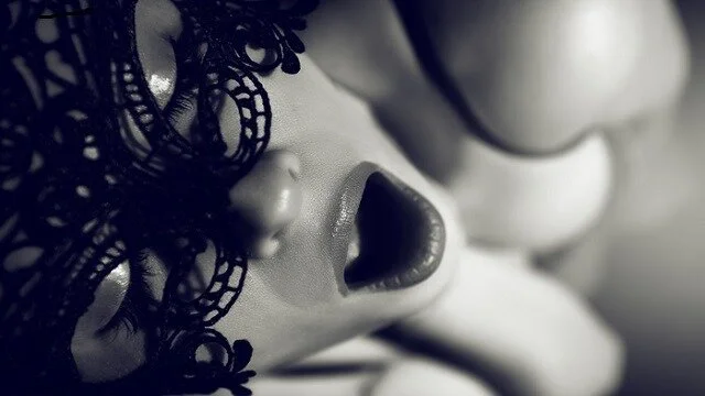 Close-up of a doll's face with dark lace hair, open mouth, and closed eyes.