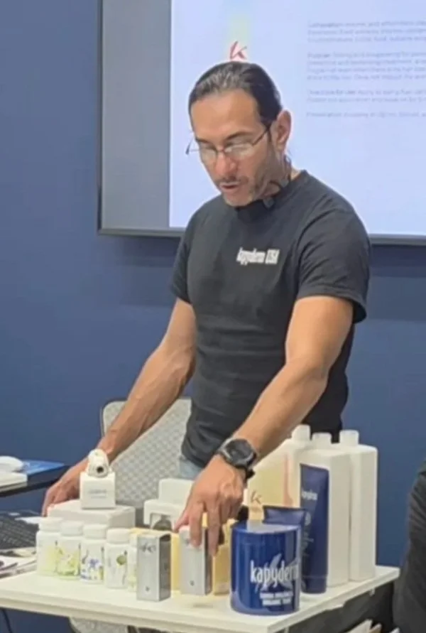 Dennis Aguilar — Kapyderm USA Operations Manager presenting the Kapyderm Dermotricology Line at a professional beauty institute