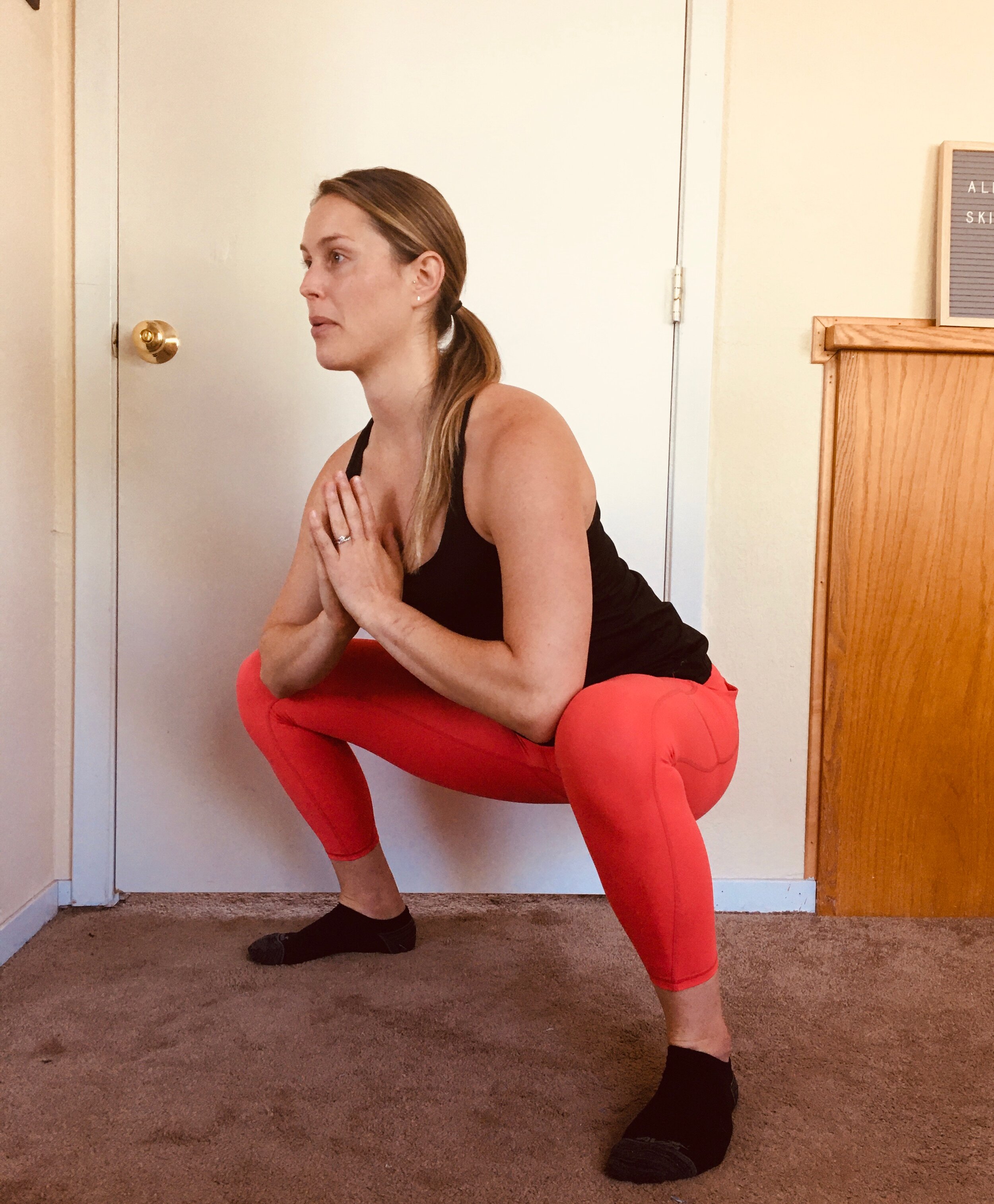 deep squat w/ elbows touching knees