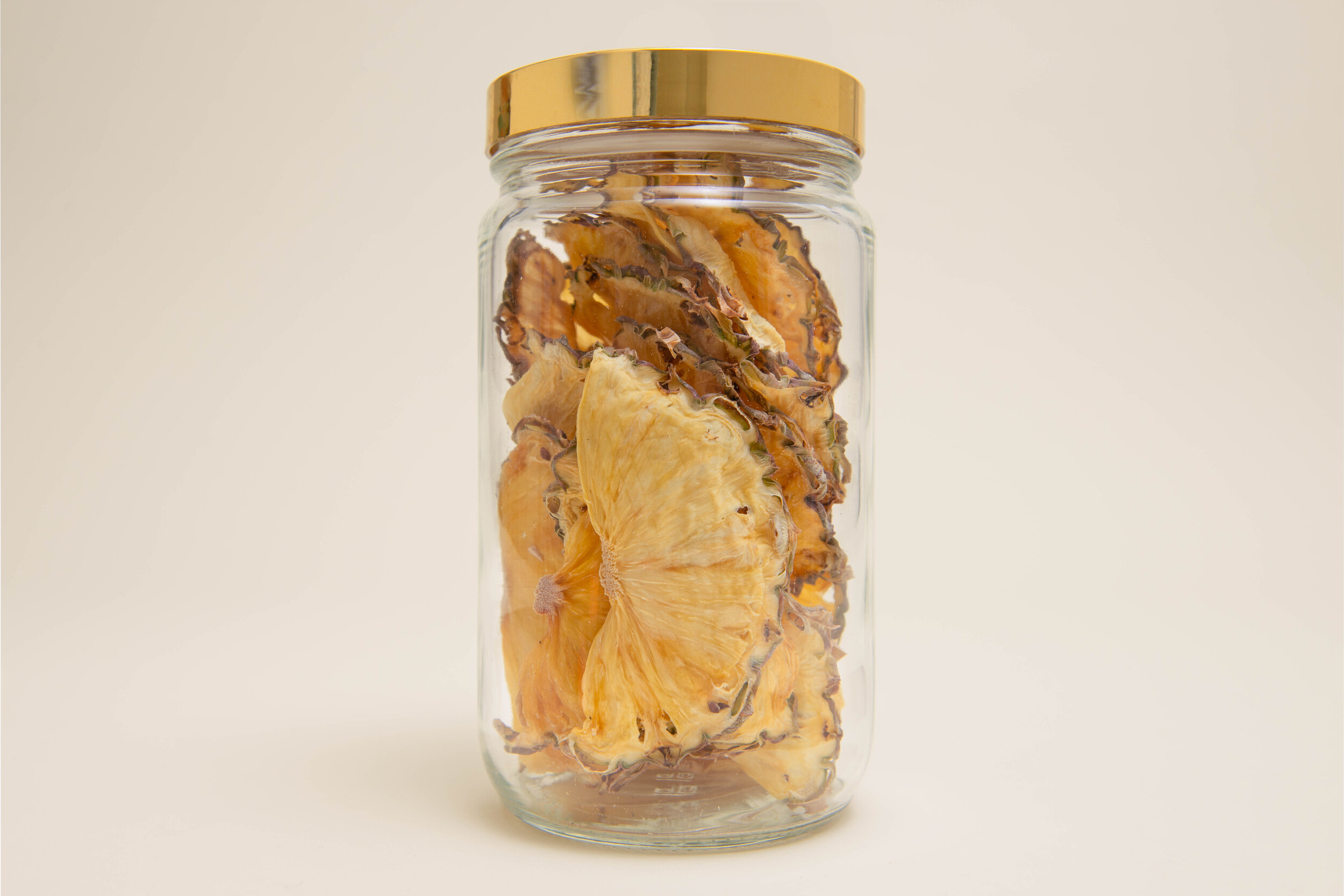Jar of half moon dehydrated pineapple garnishes for cocktails | DEHY Garnish