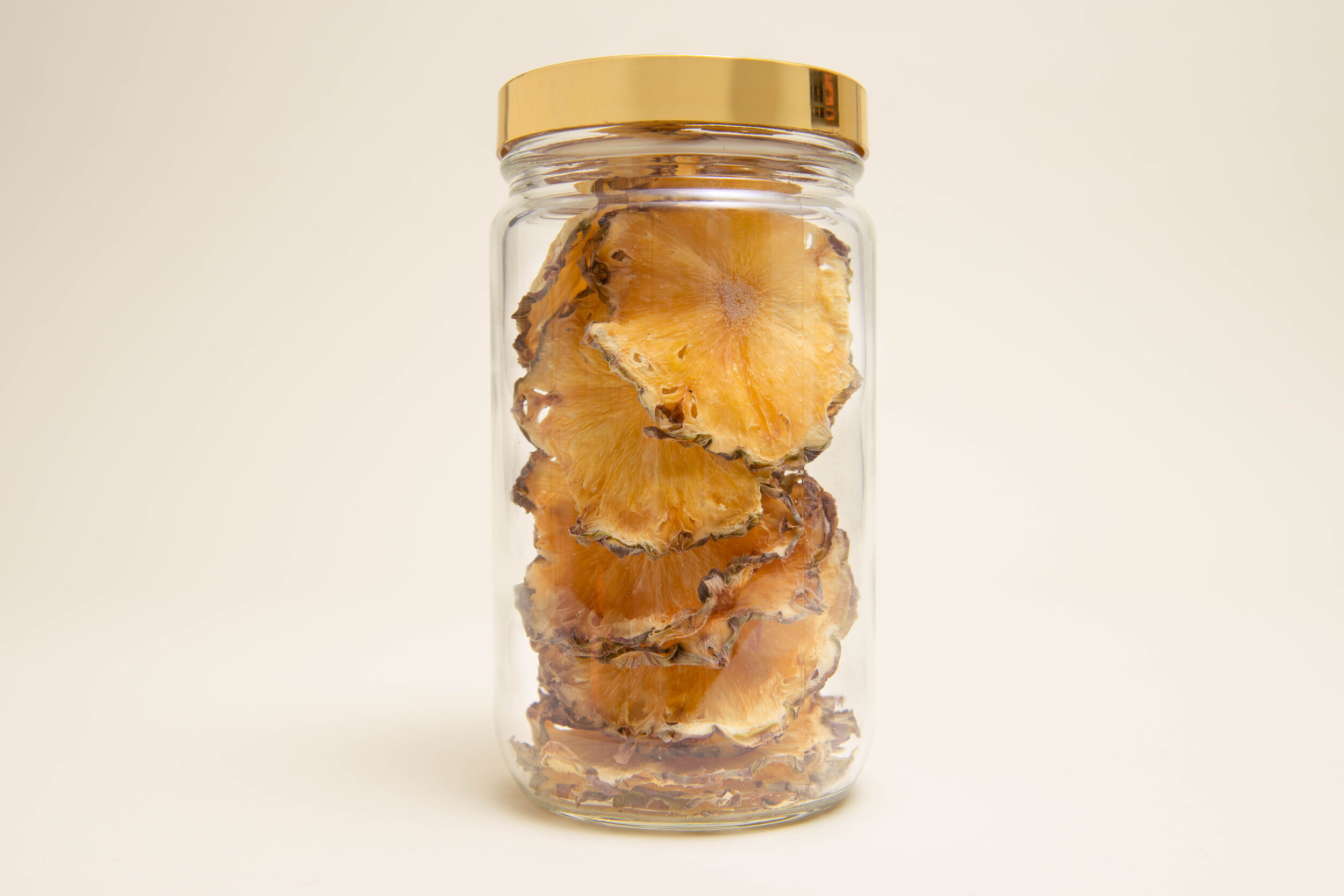 Jar of full cut dehydrated pineapple garnishes for cocktails | DEHY Garnish