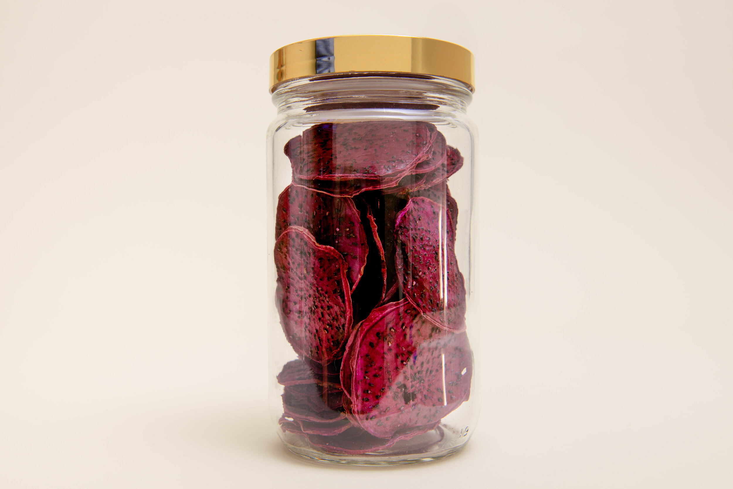 Jar of red dehydrated dragon fruit garnishes for cocktails | DEHY Garnish
