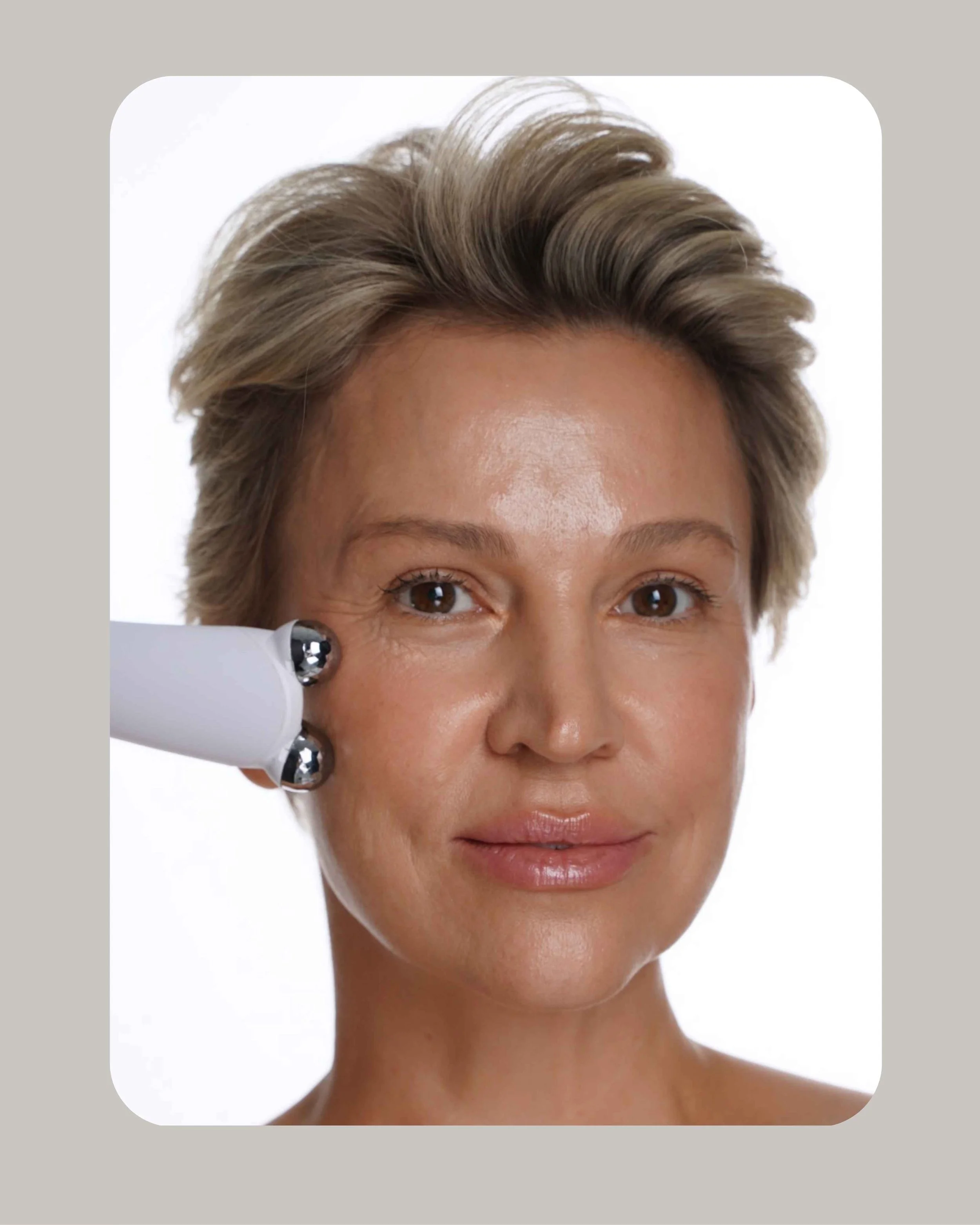 Close-up of a person receiving a facial massage, hands on forehead and cheeks.