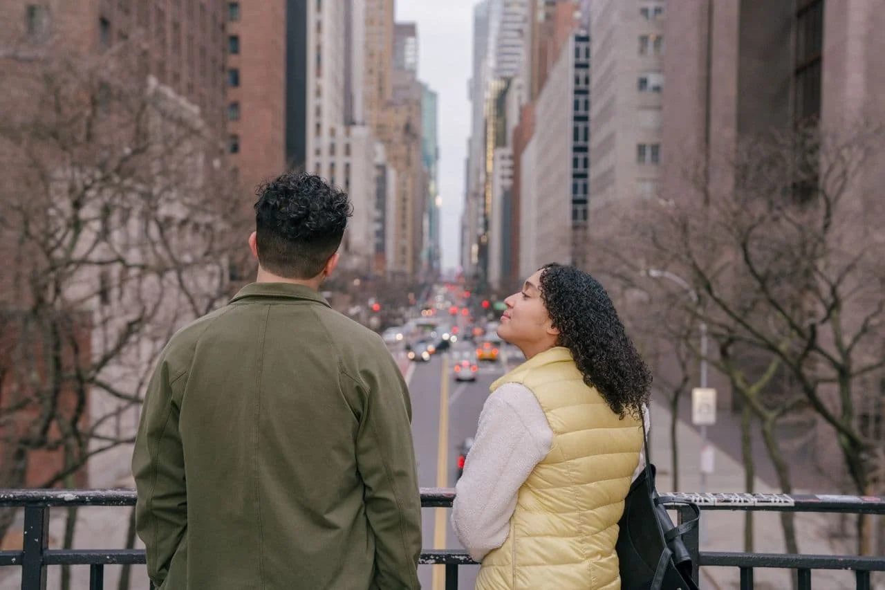 hispanic-couple-chatting-on-local-urban-bridge-over-asphalt-road