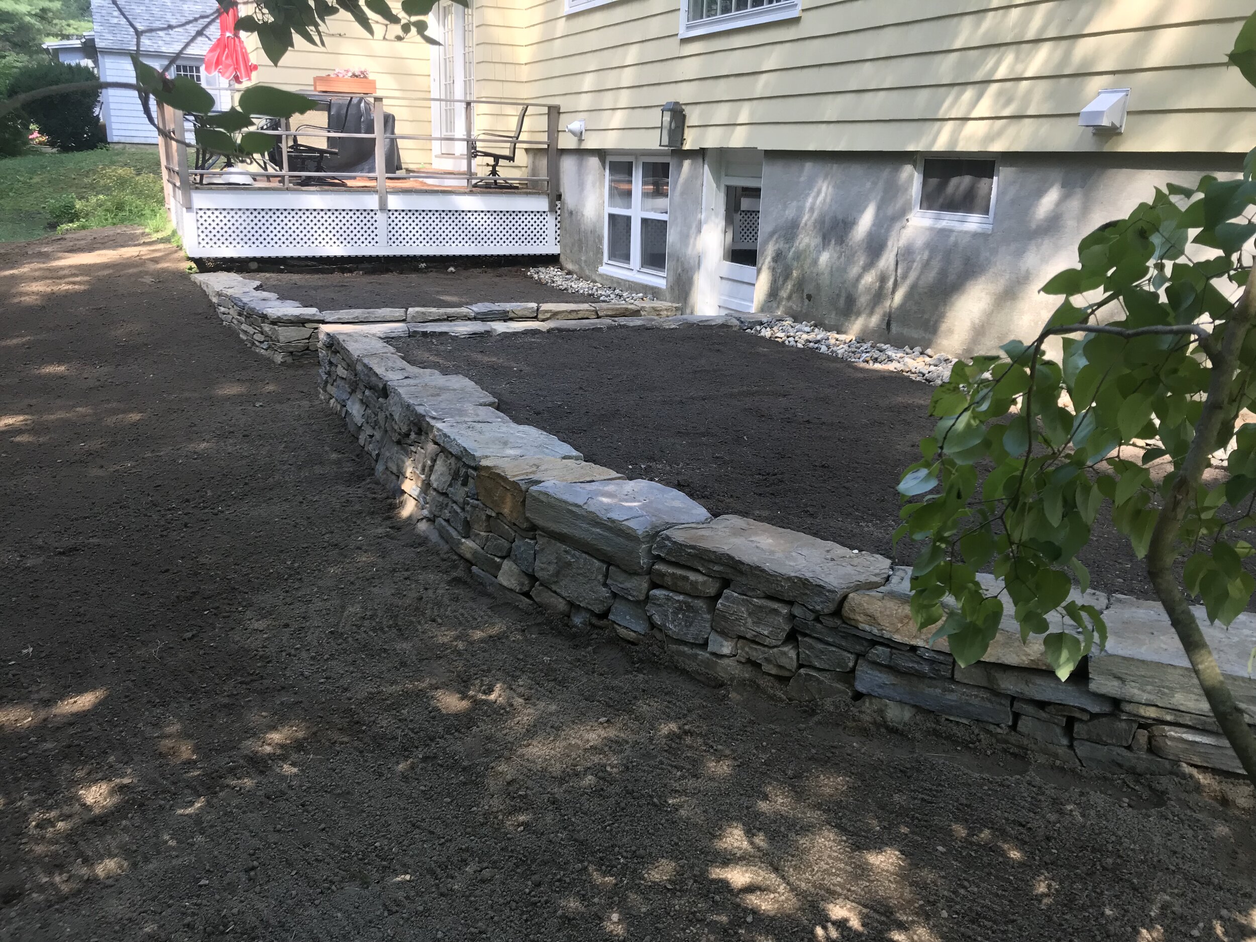 Dry laid natural stone retaining wall