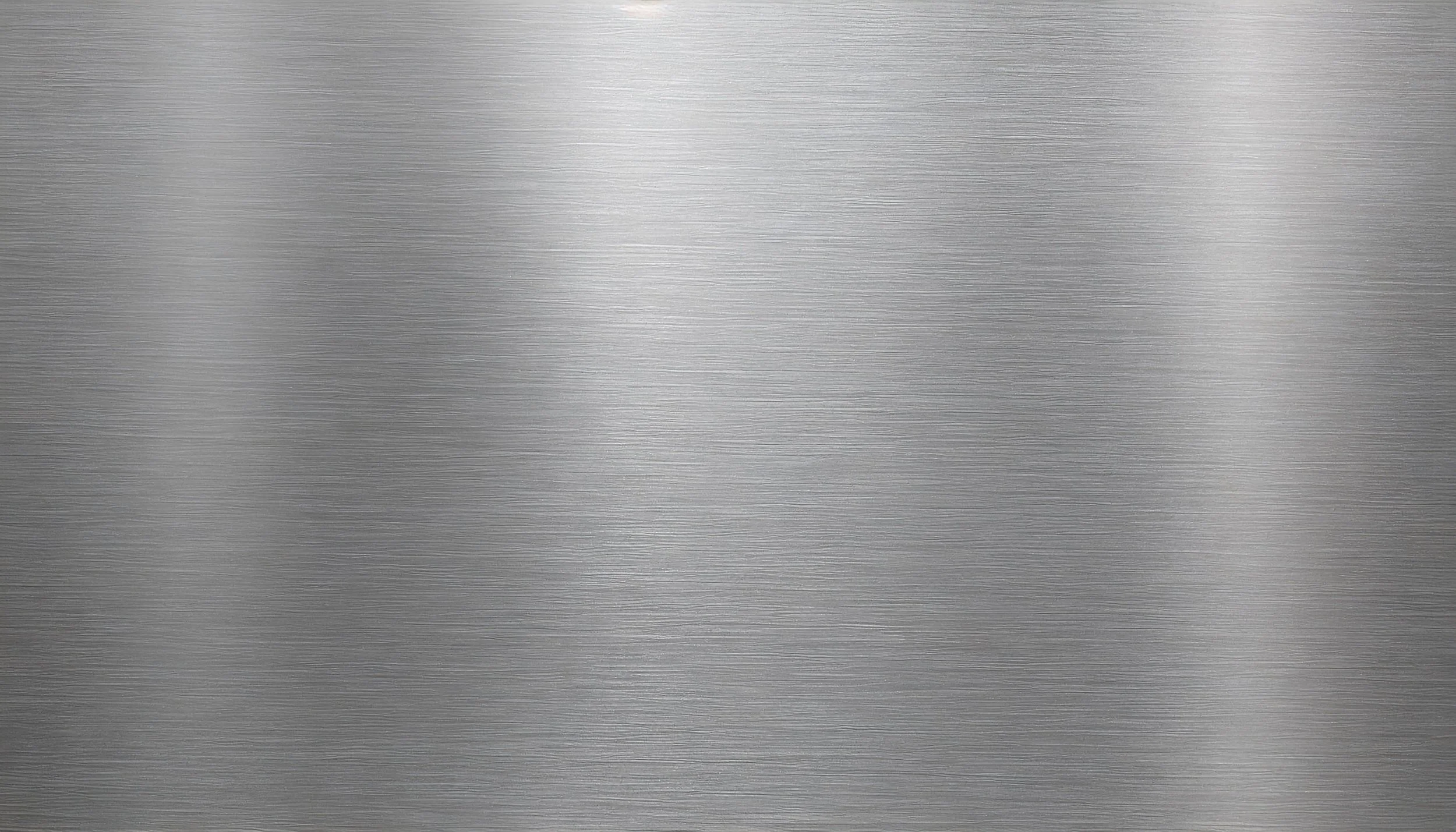 A smooth, brushed metal surface with horizontal grain lines.