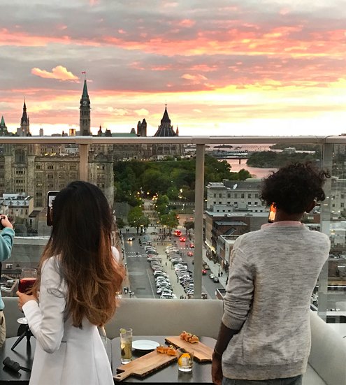 Two people watching sunset Copper Spirits and Sights Andaz Ottawa best patios
