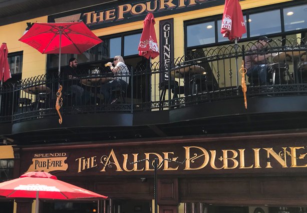 Second level patio with red umbrellas Aulde Dubliner Pour House best Ottawa patios