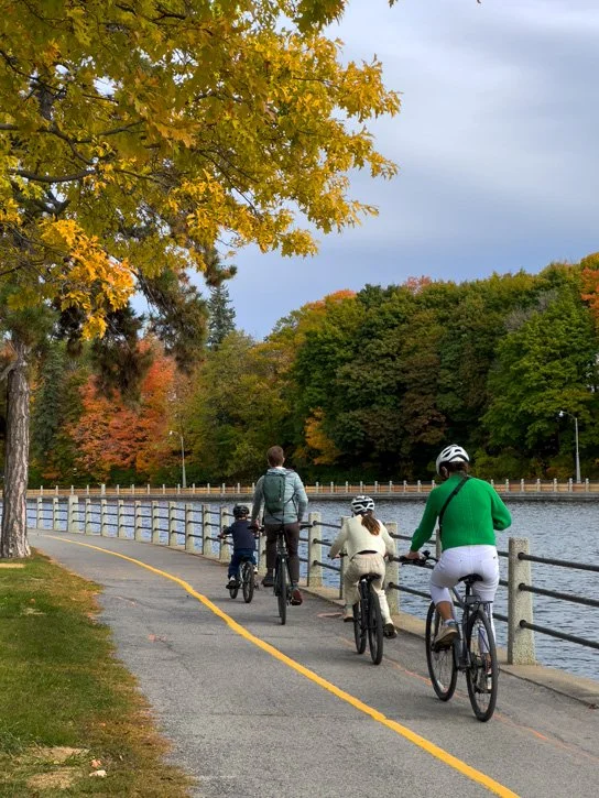Family biking along the Rideau Canal pathway Ottawa