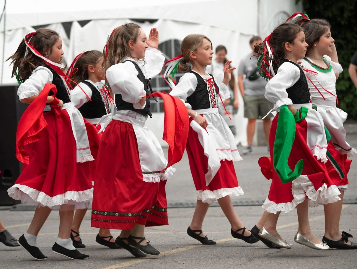 girls dressed in traditional red and white Italian outfits dancing Italian Week Ottawa festivals