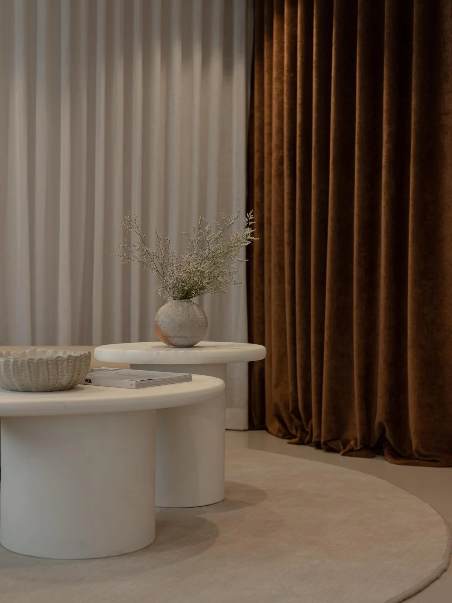 Layered tone.
Grounded texture.
Quiet contrast.

A soft textile backdrop sets the mood, while the rug anchors the space with depth and tactility. A sculptural coffee table introduces form and balance.

Nothing is competing.
Everything is considered.
