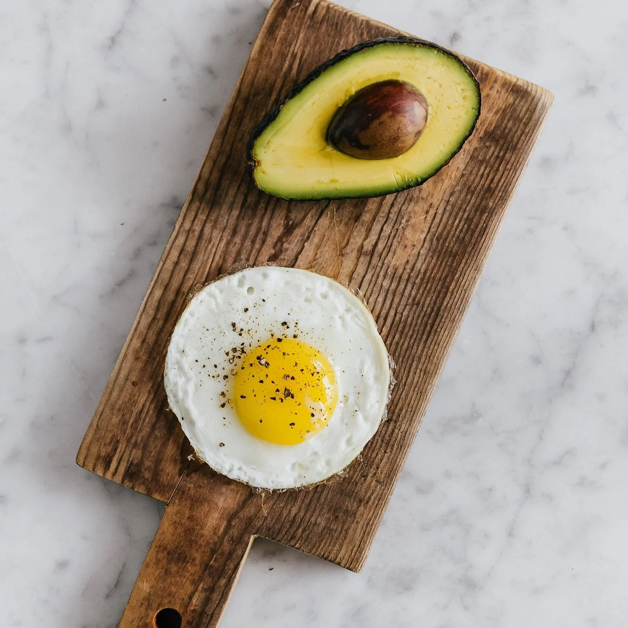avocado and eggs on a wooden board at our coffee house calgary