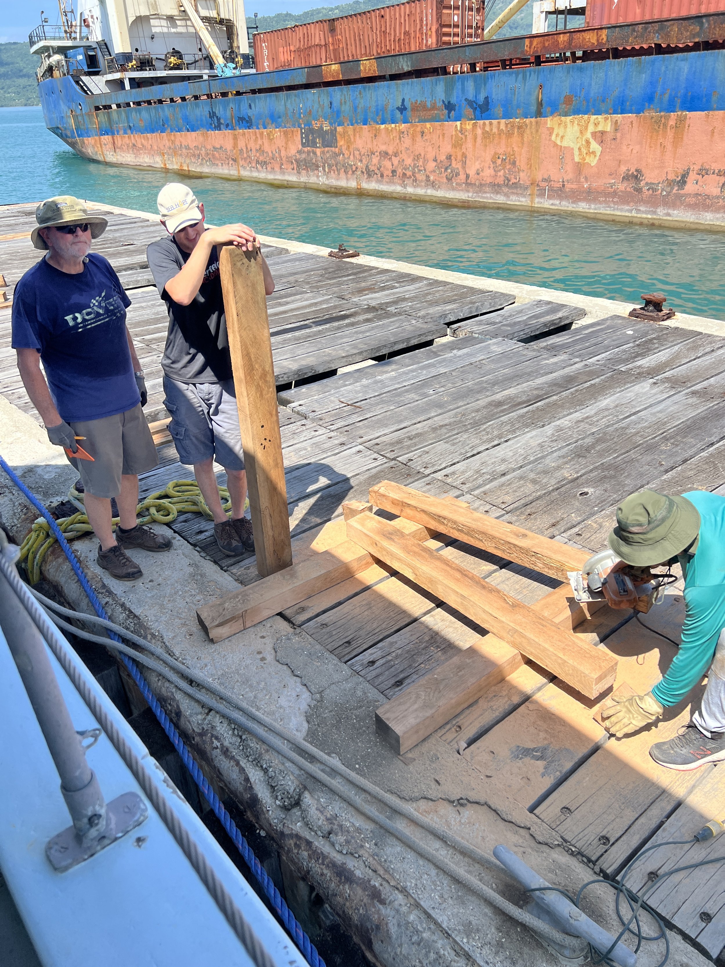  Frank Olafson, Russell Scherlie, and Cole Burge working on replacing boards on the pier in Haiti 