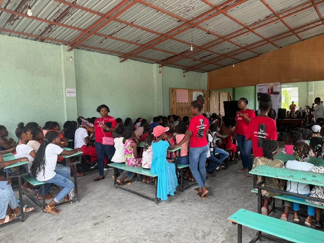 Killick and Nehemie Aristide serve in Les Cayes. They use some of the food they received to feed their Vacation Bible School children and staff