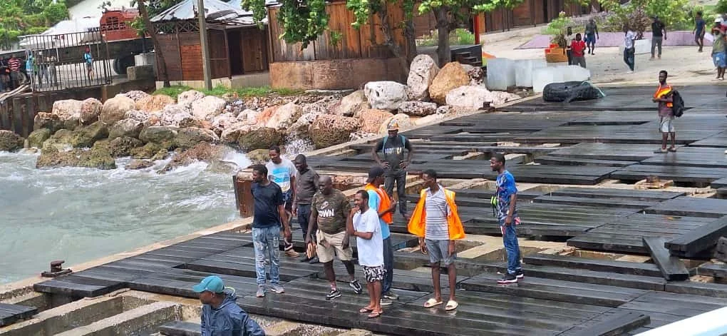 The pier is soaking wet from a horrendous rain storm that passed as well as the swells sending water waist high through the missing boards