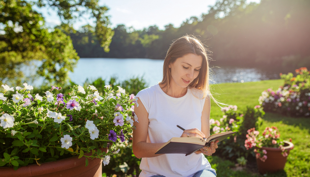 Woman outdoors on a warm summer day, illustrating how skin can still feel dry in humid weather.