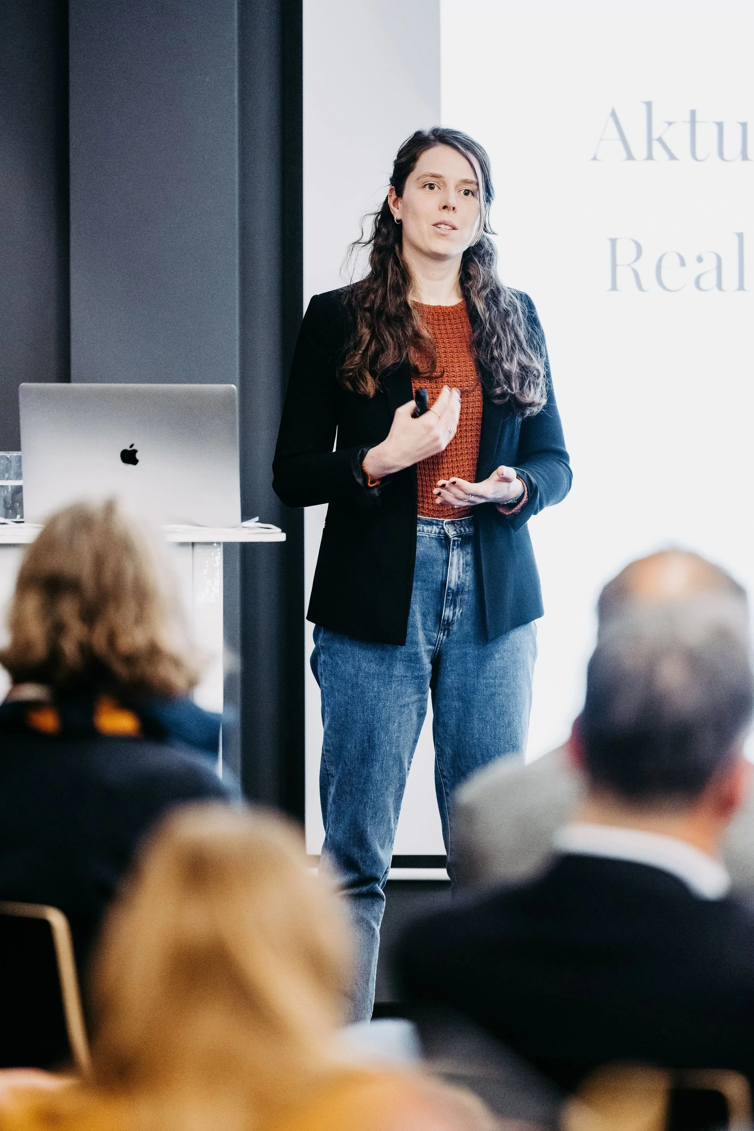 systems change speaker delivering a public presentation in front of a large audience of stakeholders and decision makers and policy makers